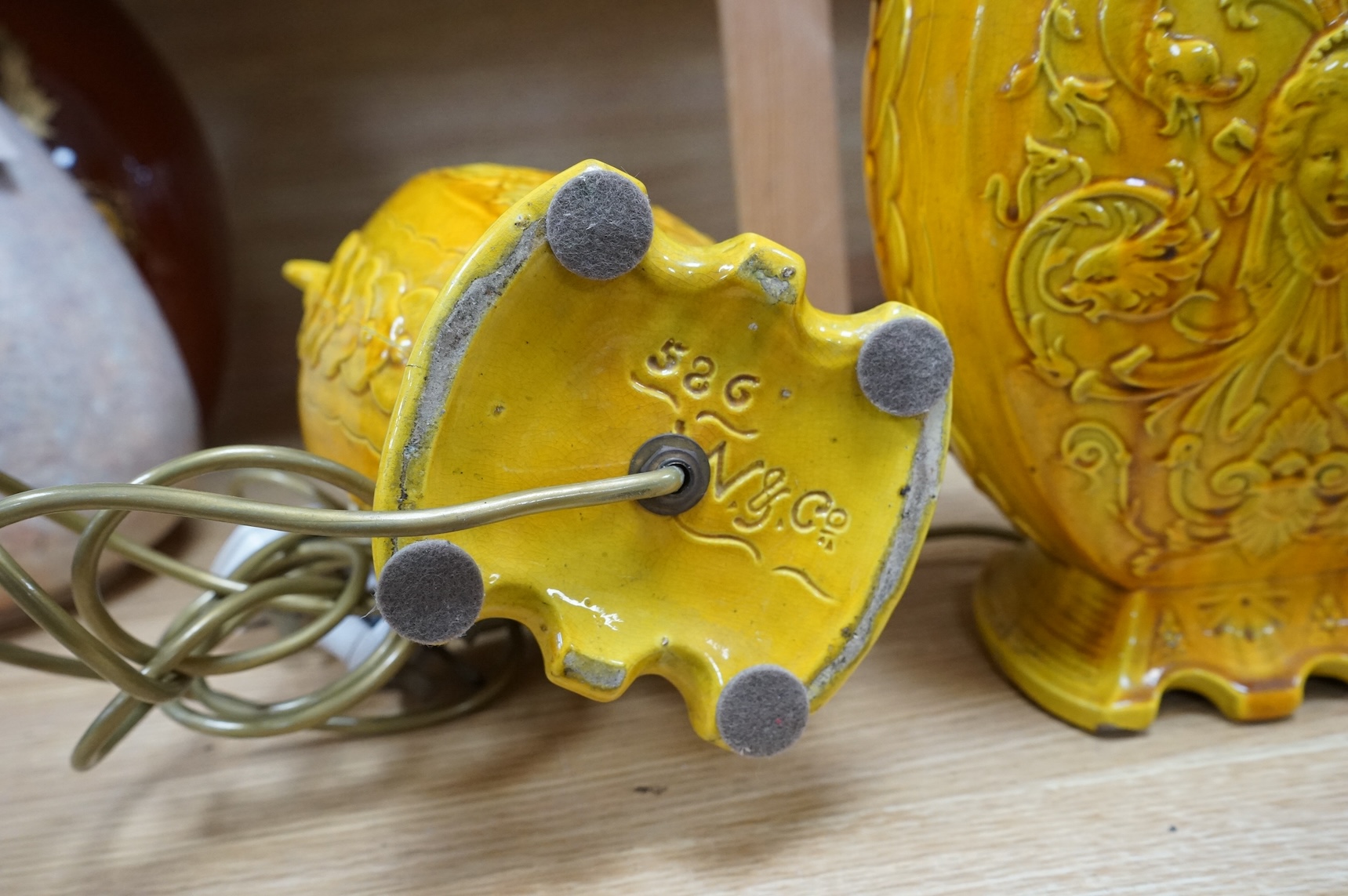 A pair of late 19th century Majolica yellow glazed vases, mounted as table lamps, marked ‘W & Co’ to base, 47cm total